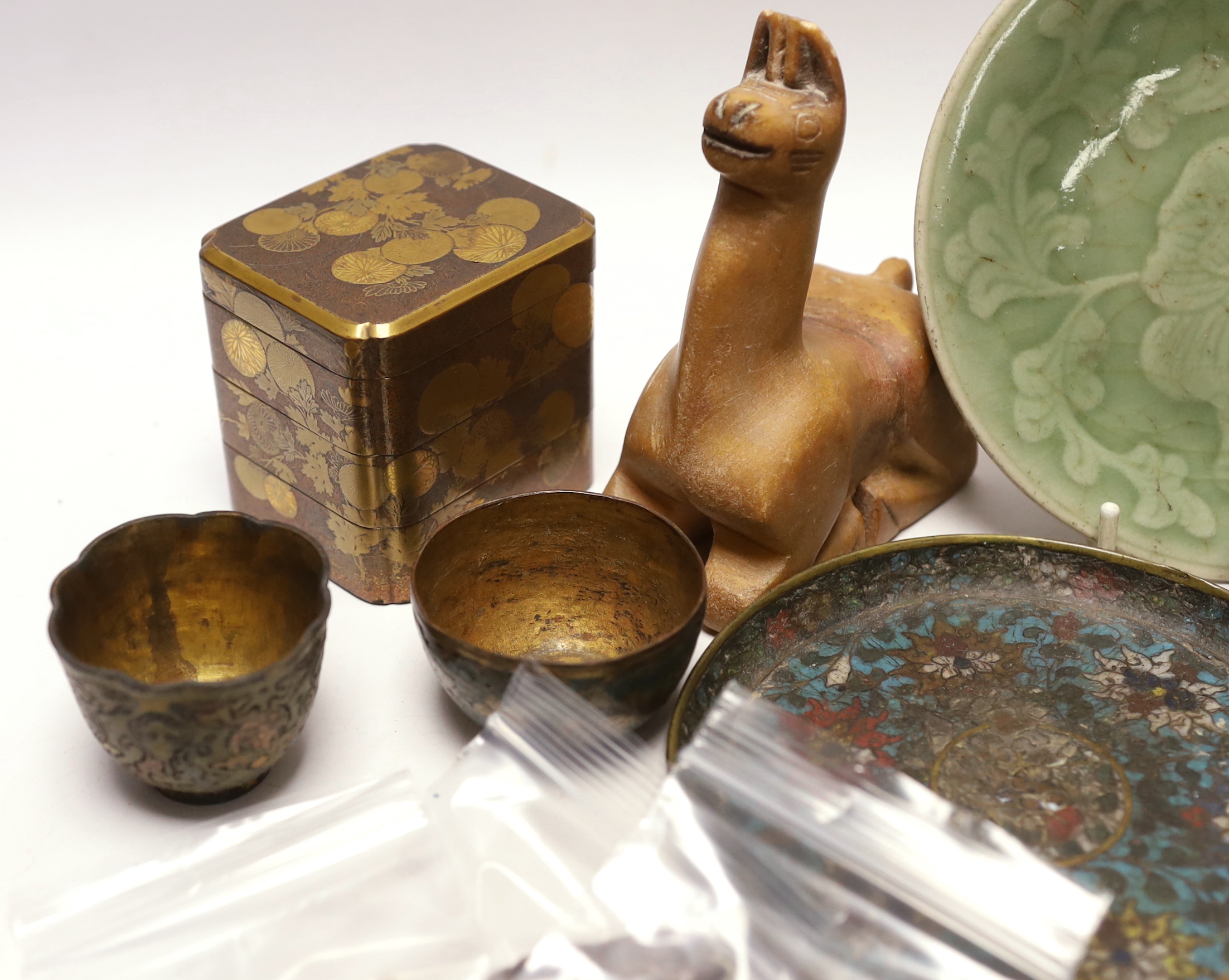 A Japanese lacquer three tier box and enamelled white metal miniature junk, gaming counters and sundries